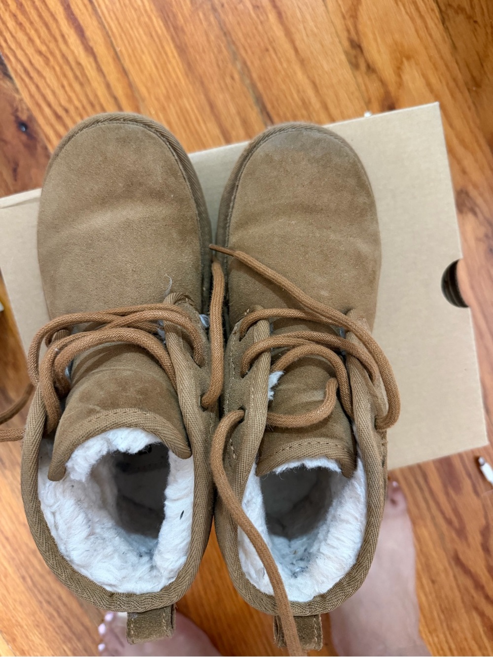 UGG kids box with black logo on tan cardboard